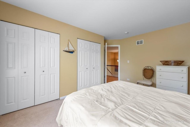 2636 Bainbridge Blvd, West Chicago, IL 60185 - bedroom featuring multiple closets and light carpet