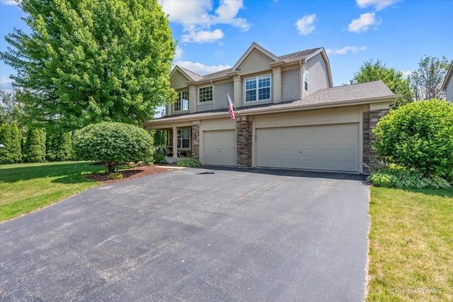2636 Bainbridge Blvd, West Chicago, IL 60185 - view of front of house with driveway, stone siding, and a front lawn