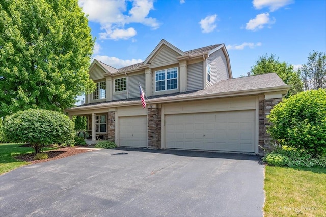 2636 Bainbridge Blvd, West Chicago, IL 60185 - view of front of property featuring asphalt driveway, stone siding, and a garage