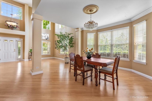 2636 Bainbridge Blvd, West Chicago, IL 60185 - dining area with light wood-style floors, plenty of natural light, decorative columns, and ornamental molding