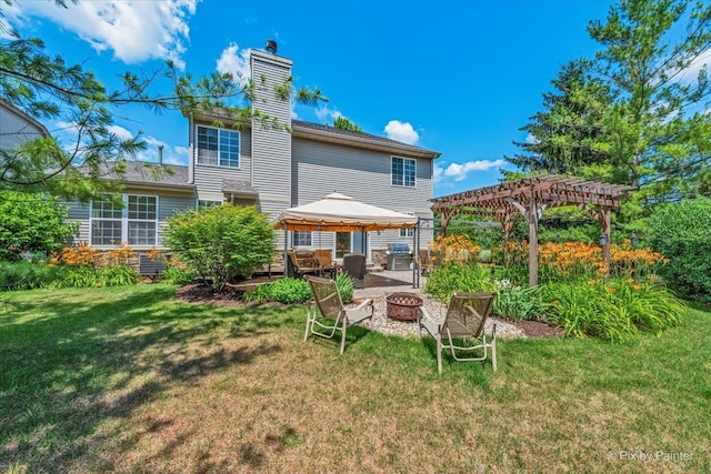 2636 Bainbridge Blvd, West Chicago, IL 60185 - back of property featuring a gazebo, an outdoor fire pit, a pergola, a chimney, and a yard