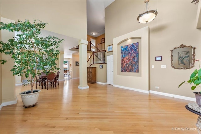 2636 Bainbridge Blvd, West Chicago, IL 60185 - entryway featuring light wood-style floors, a towering ceiling, and ornate columns