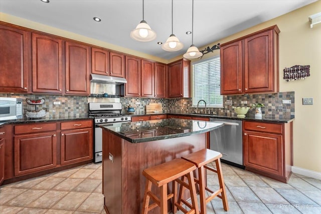 2636 Bainbridge Blvd, West Chicago, IL 60185 - kitchen with appliances with stainless steel finishes, a breakfast bar, a center island, tasteful backsplash, and pendant lighting