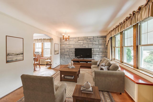 6339 S Kostner Ave, Chicago, IL 60629 - living room featuring arched walkways, a chandelier, and wood finished floors