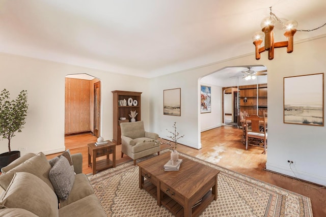 6339 S Kostner Ave, Chicago, IL 60629 - living area with arched walkways, ceiling fan, and light wood-style floors