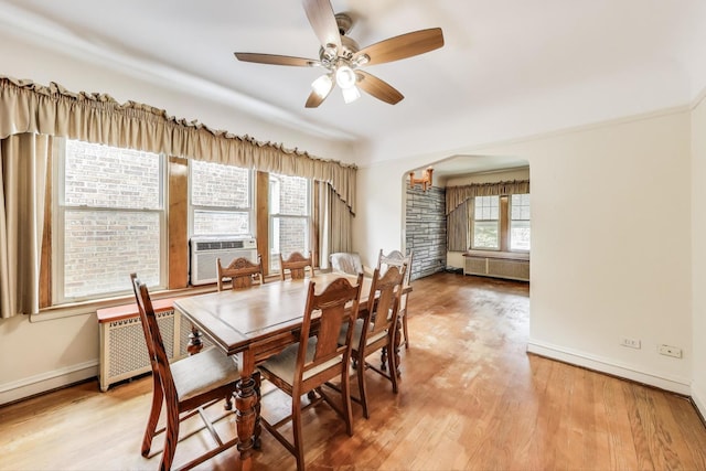 6339 S Kostner Ave, Chicago, IL 60629 - dining area featuring radiator, arched walkways, wood finished floors, and a ceiling fan