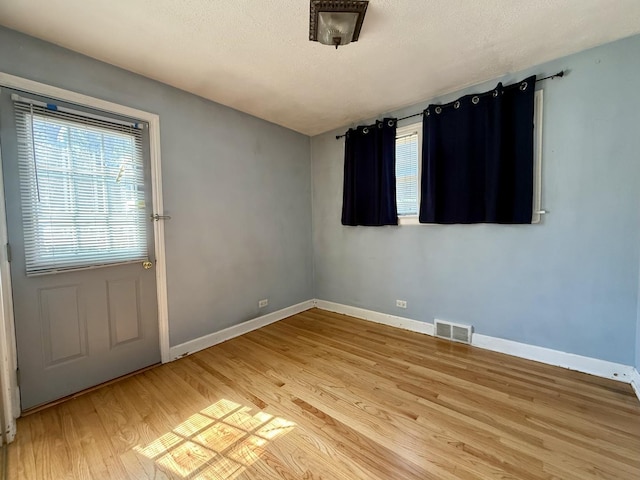9424 Lorel Ave, Skokie, IL 60077 - empty room featuring light wood finished floors and a textured ceiling