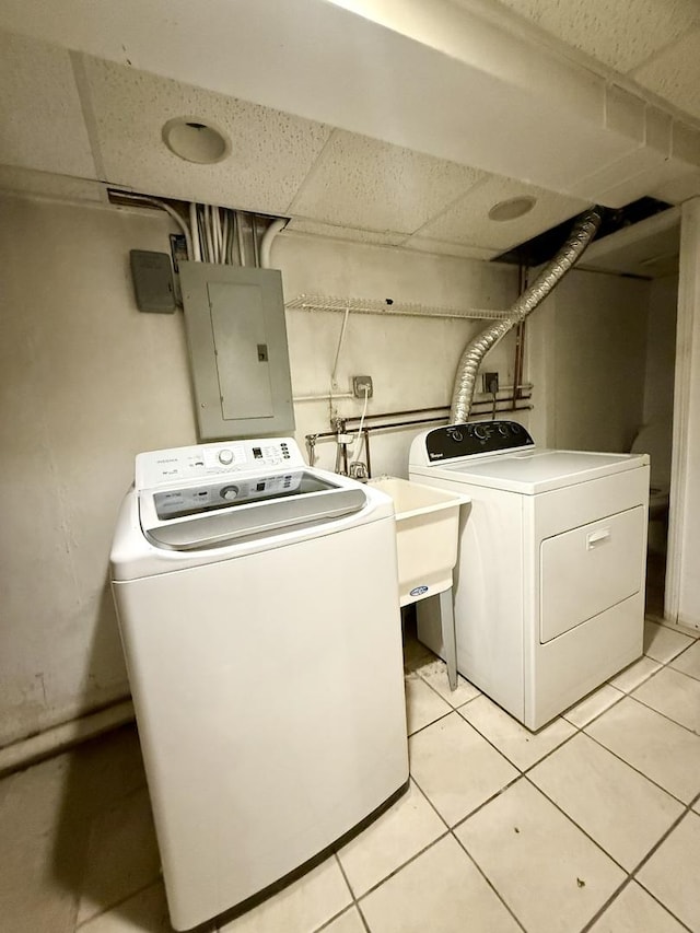9424 Lorel Ave, Skokie, IL 60077 - laundry room featuring washer and clothes dryer, electric panel, and light tile patterned flooring