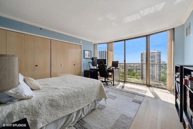 1440 N State Pkwy Unit 21C, Chicago, IL 60610 - bedroom with a wall of windows, ornamental molding, wood finished floors, an office area, and access to outside