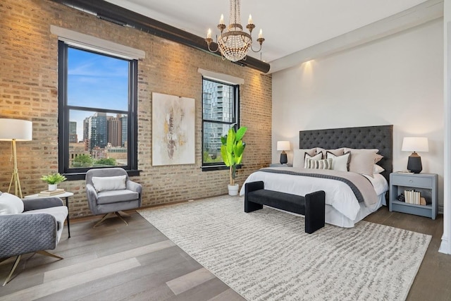401 N Aberdeen St Unit 4S, Chicago, IL 60642 - bedroom with a chandelier, wood finished floors, and brick wall