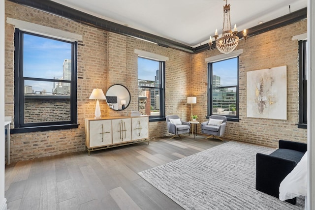401 N Aberdeen St Unit 4S, Chicago, IL 60642 - living area with brick wall, wood finished floors, a chandelier, and a high ceiling