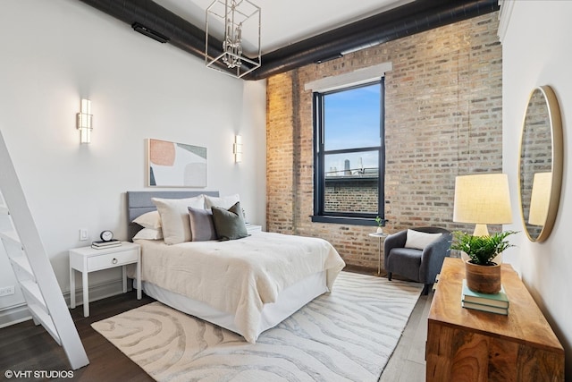 401 N Aberdeen St Unit 4S, Chicago, IL 60642 - bedroom with brick wall, wood finished floors, and a chandelier