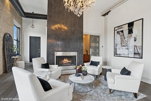 401 N Aberdeen St Unit 4S, Chicago, IL 60642 - living room with a high ceiling, a lit fireplace, a chandelier, and wood finished floors