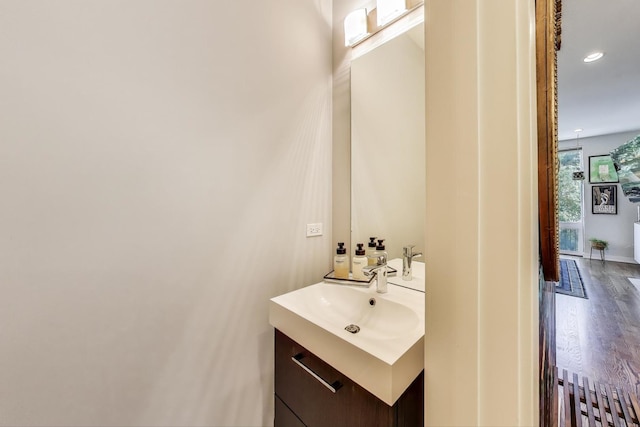 1800 N California Ave Unit 1E, Chicago, IL 60647 - bathroom featuring vanity, wood finished floors, and recessed lighting