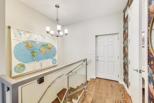 1800 N California Ave Unit 1E, Chicago, IL 60647 - entryway with a chandelier and light wood-type flooring