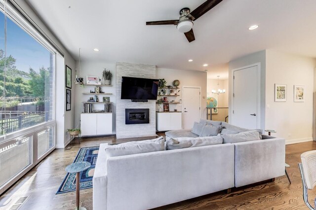 1800 N California Ave Unit 1E, Chicago, IL 60647 - living room featuring a ceiling fan, a large fireplace, wood finished floors, recessed lighting, and a chandelier