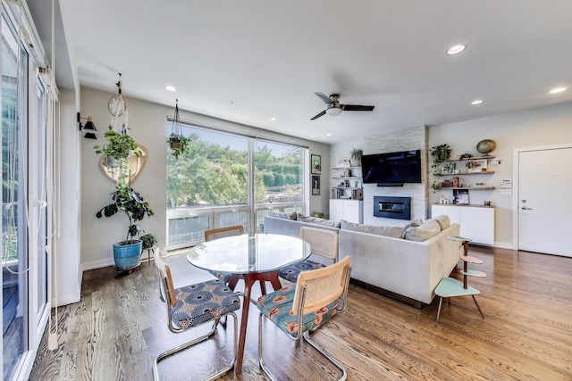 1800 N California Ave Unit 1E, Chicago, IL 60647 - dining space featuring ceiling fan, a large fireplace, wood finished floors, and recessed lighting