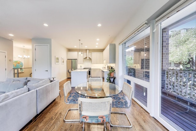 1800 N California Ave Unit 1E, Chicago, IL 60647 - dining area featuring light wood-style floors, a chandelier, and recessed lighting