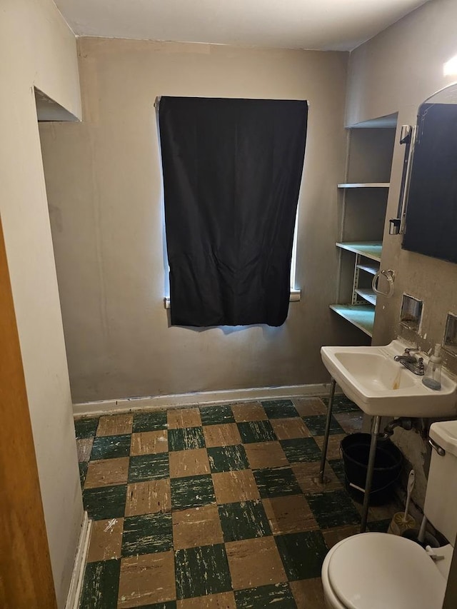 3711 W 68th Pl, Chicago, IL 60629 - half bath featuring a sink and tile patterned floors