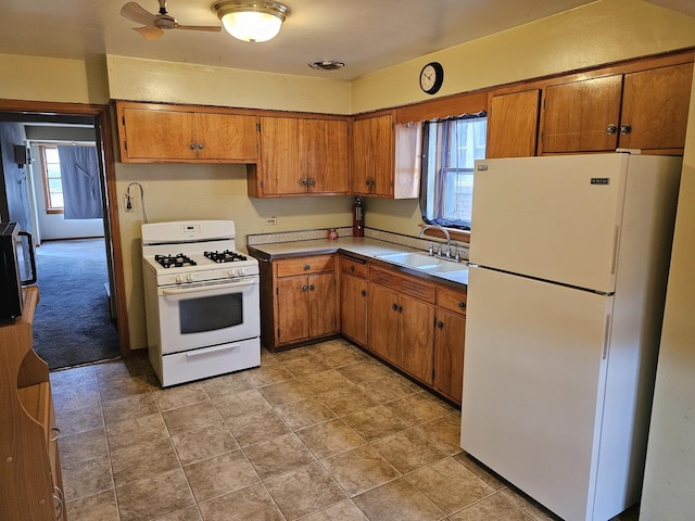 3711 W 68th Pl, Chicago, IL 60629 - kitchen featuring white appliances, brown cabinets, a ceiling fan, and light countertops