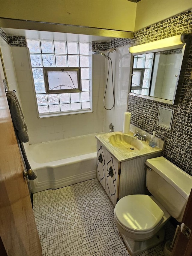 3711 W 68th Pl, Chicago, IL 60629 - bathroom featuring tile walls, shower / bath combination, vanity, and tasteful backsplash