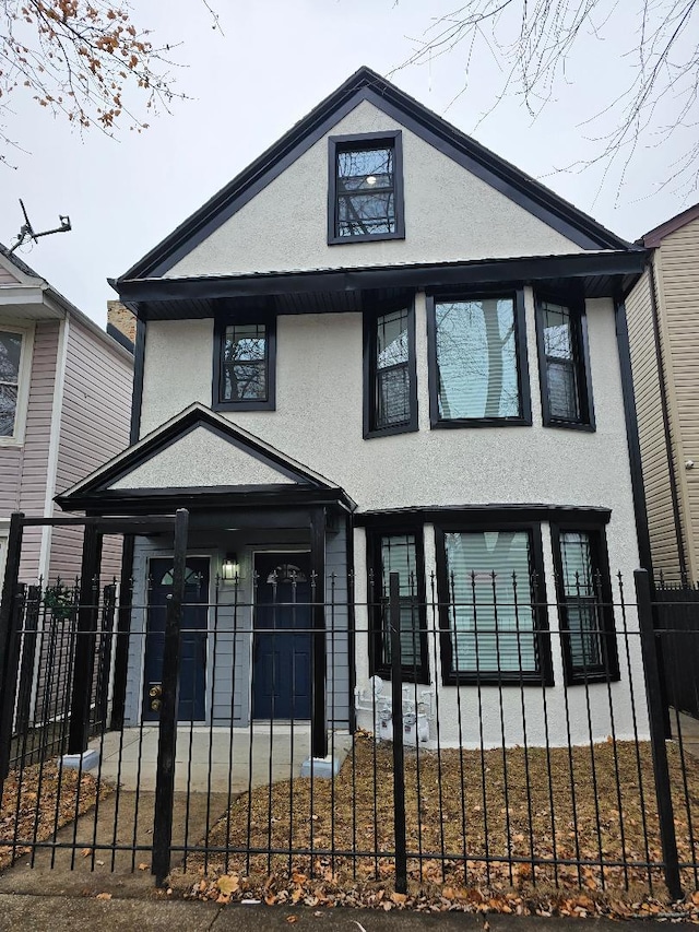 8809 S Lowe Ave, Chicago, IL 60620 - view of front of house featuring stucco siding and a fenced front yard