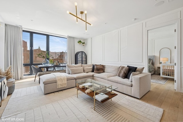 2405 W Iowa St Unit 206, Chicago, IL 60622 - living room with a decorative wall, light wood finished floors, and a wall of windows