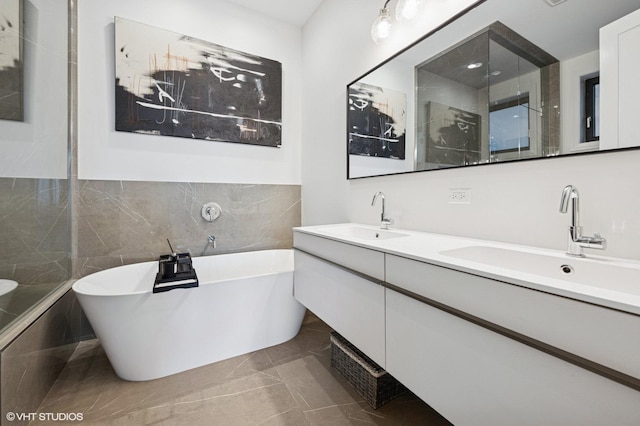 2405 W Iowa St Unit 206, Chicago, IL 60622 - bathroom with a freestanding bath, double vanity, tile walls, marble finish flooring, and a shower