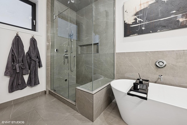 2405 W Iowa St Unit 206, Chicago, IL 60622 - bathroom featuring marble tiled flooring, a stall shower, a soaking tub, and tile walls