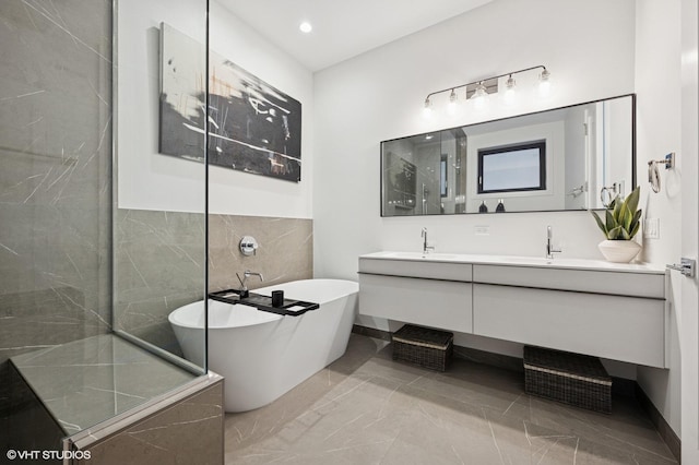 2405 W Iowa St Unit 206, Chicago, IL 60622 - bathroom with double vanity, a freestanding bath, marble finish floors, a shower, and tile walls