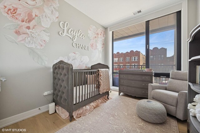 2405 W Iowa St Unit 206, Chicago, IL 60622 - bedroom featuring wood finished floors and baseboards