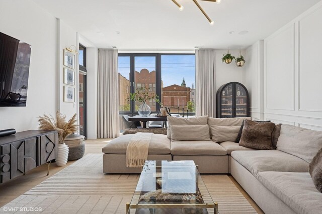 2405 W Iowa St Unit 206, Chicago, IL 60622 - living area with wood finished floors, floor to ceiling windows, and a decorative wall