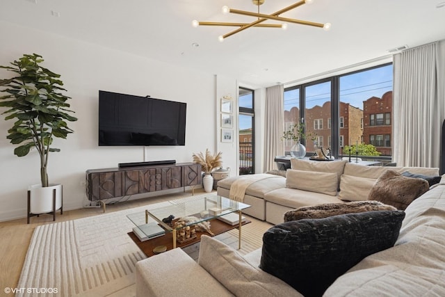 2405 W Iowa St Unit 206, Chicago, IL 60622 - living area featuring wood finished floors, a chandelier, and expansive windows