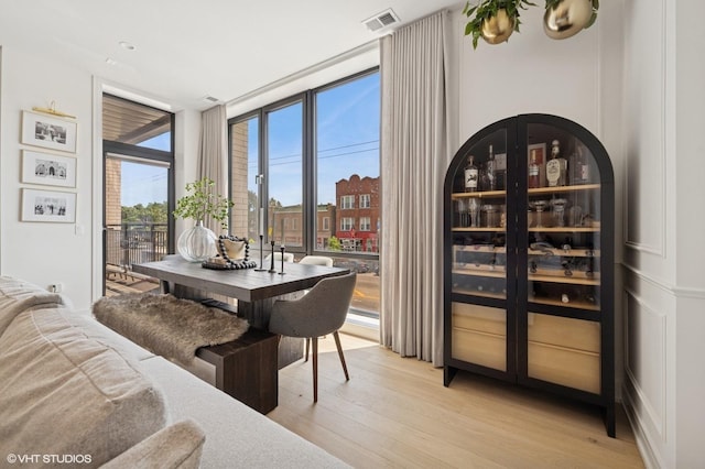 2405 W Iowa St Unit 206, Chicago, IL 60622 - dining room featuring a wall of windows and light wood-type flooring