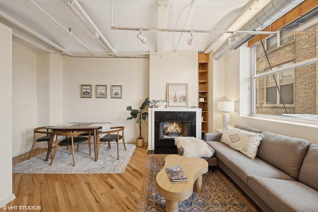 500 S Clinton St Unit 517, Chicago, IL 60607 - living area with wood finished floors, a fireplace, and track lighting