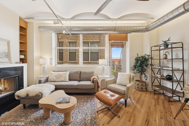 500 S Clinton St Unit 517, Chicago, IL 60607 - living area featuring wood finished floors, a warm lit fireplace, and built in shelves