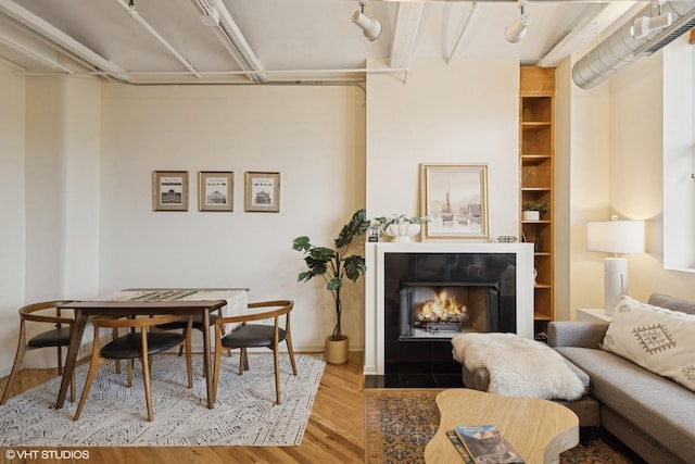 500 S Clinton St Unit 517, Chicago, IL 60607 - dining space with wood finished floors, a tiled fireplace, and built in features