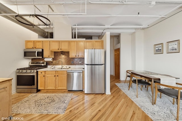 500 S Clinton St Unit 517, Chicago, IL 60607 - kitchen with appliances with stainless steel finishes, light wood finished floors, decorative backsplash, and light countertops
