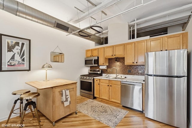 500 S Clinton St Unit 517, Chicago, IL 60607 - kitchen with stainless steel appliances, backsplash, light countertops, light brown cabinetry, and a high ceiling