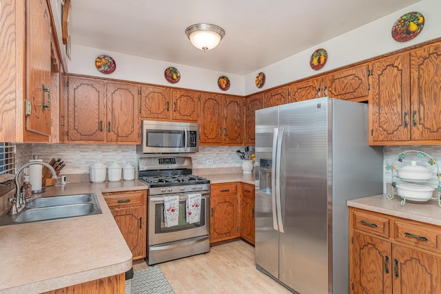 8712 Carriage Ln, Tinley Park, IL 60487 - kitchen featuring stainless steel appliances, brown cabinets, and backsplash
