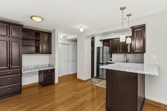 2909 N Sheridan Rd Unit 1601, Chicago, IL 60657 - kitchen with freestanding refrigerator, dark brown cabinetry, a peninsula, tasteful backsplash, and open shelves