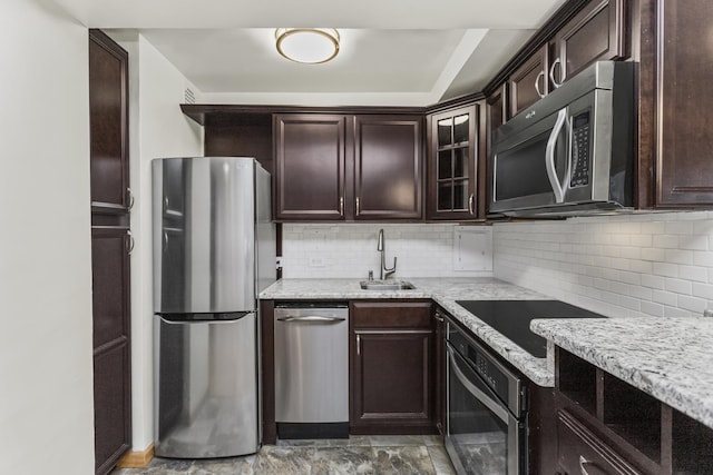 2909 N Sheridan Rd Unit 1601, Chicago, IL 60657 - kitchen with appliances with stainless steel finishes, dark brown cabinets, light stone countertops, and decorative backsplash