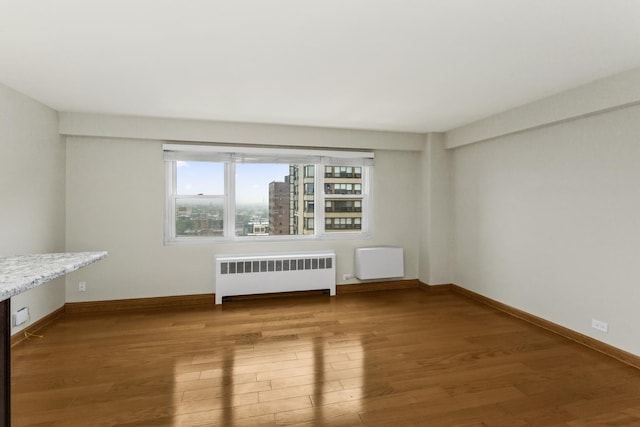 2909 N Sheridan Rd Unit 1601, Chicago, IL 60657 - unfurnished living room with radiator heating unit and wood finished floors