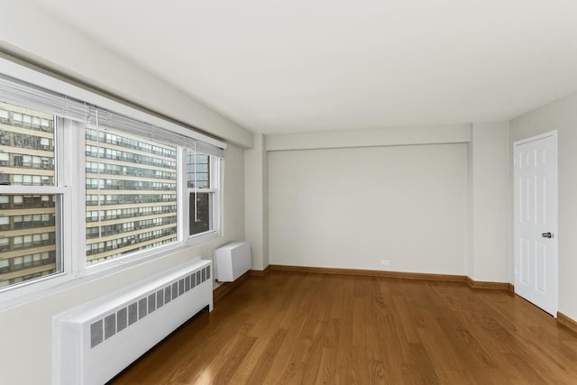 2909 N Sheridan Rd Unit 1601, Chicago, IL 60657 - spare room with radiator heating unit and wood finished floors