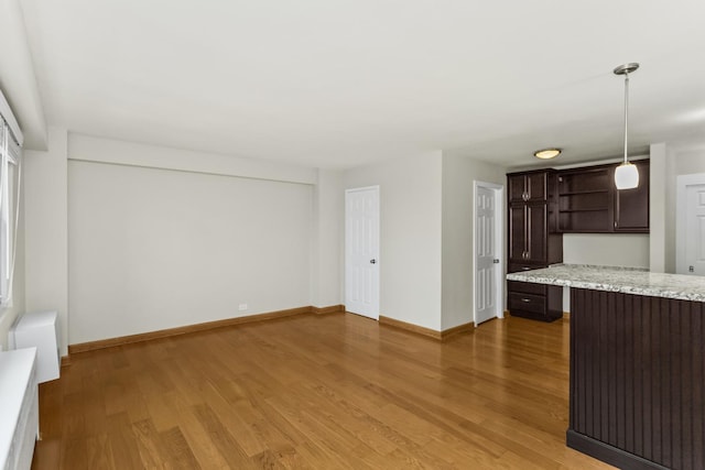 2909 N Sheridan Rd Unit 1601, Chicago, IL 60657 - unfurnished living room featuring baseboards and light wood finished floors