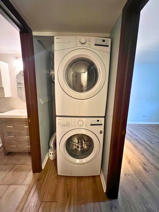 2310 Woodbridge Way Unit 1B, Lombard, IL 60148 - washroom featuring stacked washer / drying machine and wood finished floors