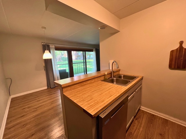2310 Woodbridge Way Unit 1B, Lombard, IL 60148 - kitchen with dishwasher, dark wood finished floors, a peninsula, hanging light fixtures, and light countertops
