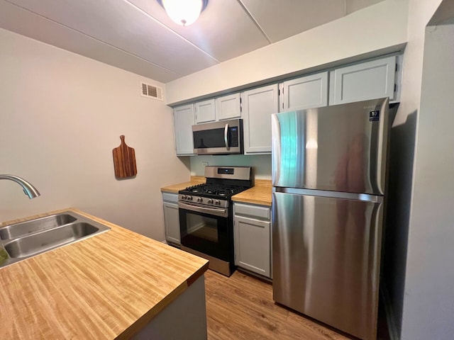 2310 Woodbridge Way Unit 1B, Lombard, IL 60148 - kitchen featuring stainless steel appliances, wooden counters, and gray cabinetry