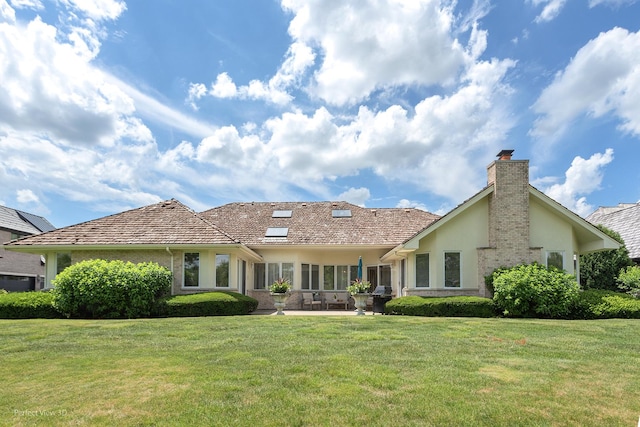 17 Ruffled Feathers Dr, Lemont, IL 60439 - rear view of house featuring a chimney, stucco siding, and a yard
