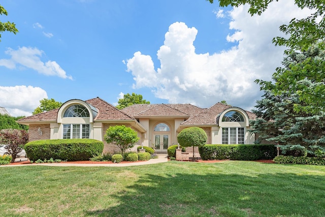 17 Ruffled Feathers Dr, Lemont, IL 60439 - view of front of house featuring french doors, a front lawn, and stucco siding